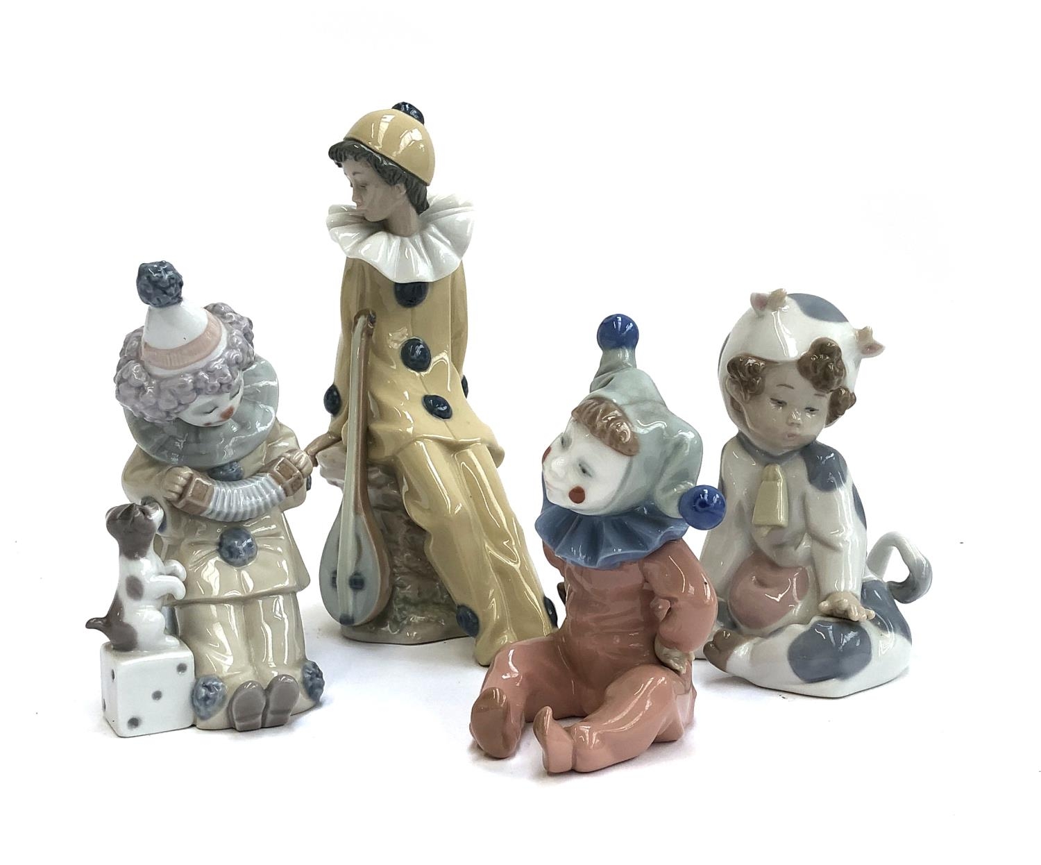 Four Lladro figurines, three stamped Nao, to include child dressed as cow, no. 1415, child dressed