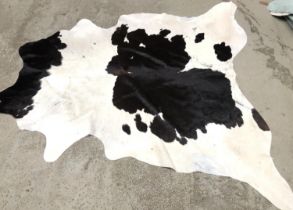 A cowhide rug, approx 205x198cm