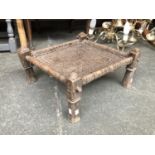 An Indian hardwood and hide stool, 47x43x23cmH