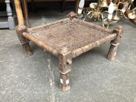 An Indian hardwood and hide stool, 47x43x23cmH