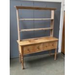 A 19th century pine kitchen dresser, the rack with two shelves, over a base of two drawers, on