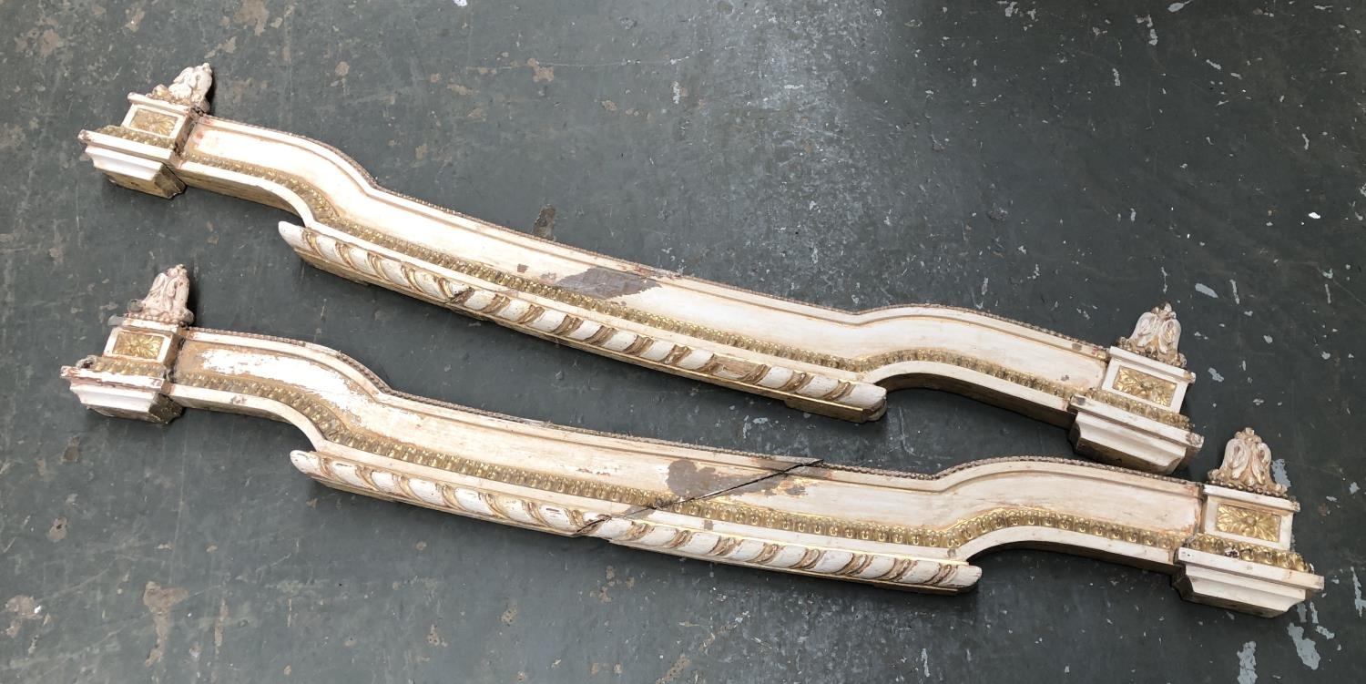 A pair of French carved, painted and parcel gilt curtain pelmets, 140cm wide
