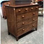 A late George III mahogany chest of two short over three graduating drawers, with turned wooden