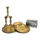 Three large brass candlesticks, together with a quantity brass plates and engraved chargers, etc