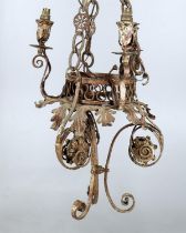 A Continental painted wrought metal three light chandelier, of scrolling form, 47cm high.