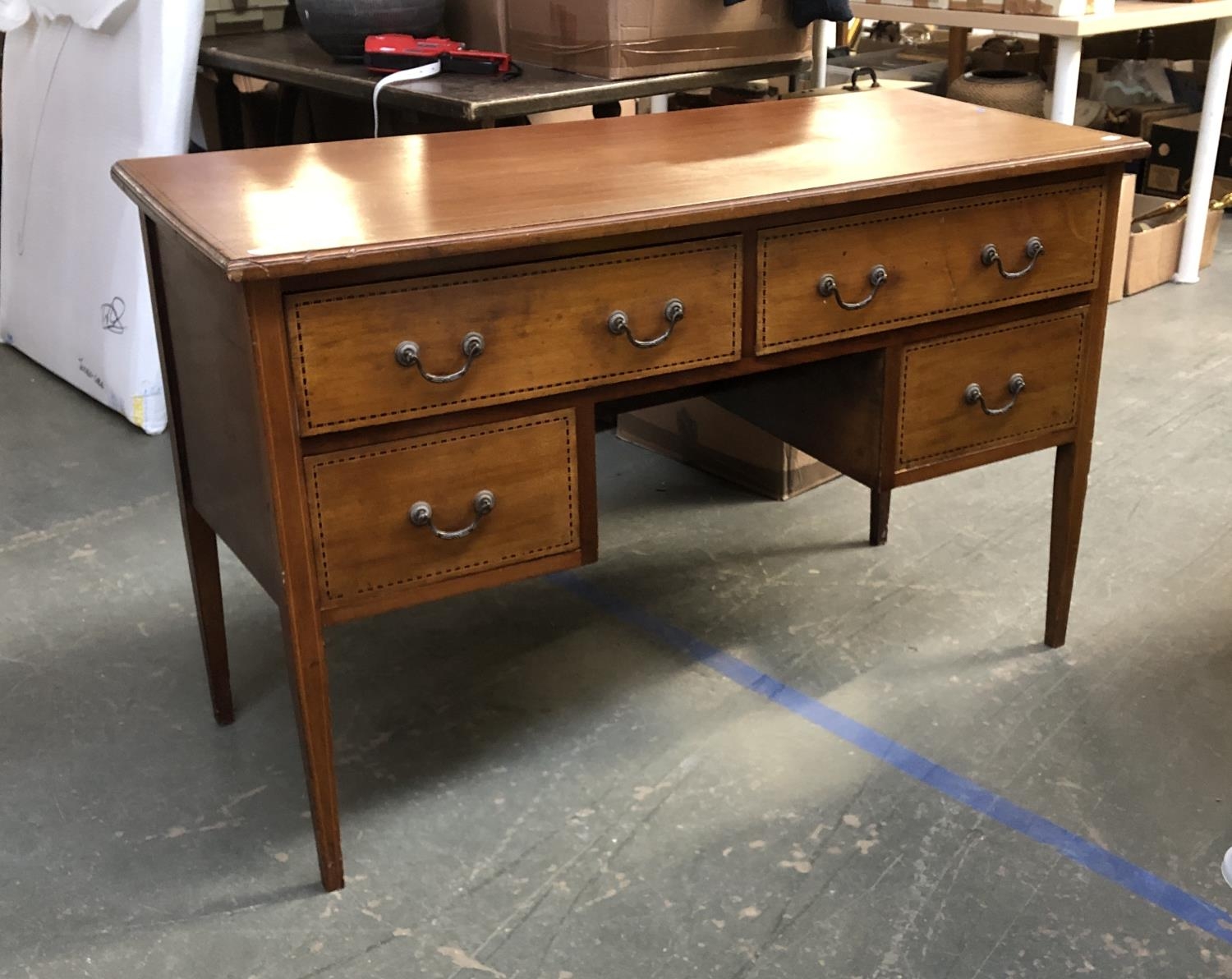 An early 20th century mahogany dressing table, with four drawers surrounding a kneehole,