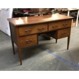 An early 20th century mahogany dressing table, with four drawers surrounding a kneehole,