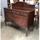A 20th century mahogany sideboard in the 18th century taste, with gardrooned edge over two drawers