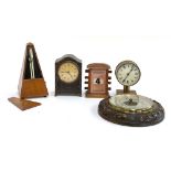 A Maelzel metronome; a early 20th century desk calendar; two clocks; and a carved aneroid barometer