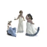 Three Nao by Lladro figures, girl holding candle, no. 1155, 26cmH, girl posing, no. 1391, girl