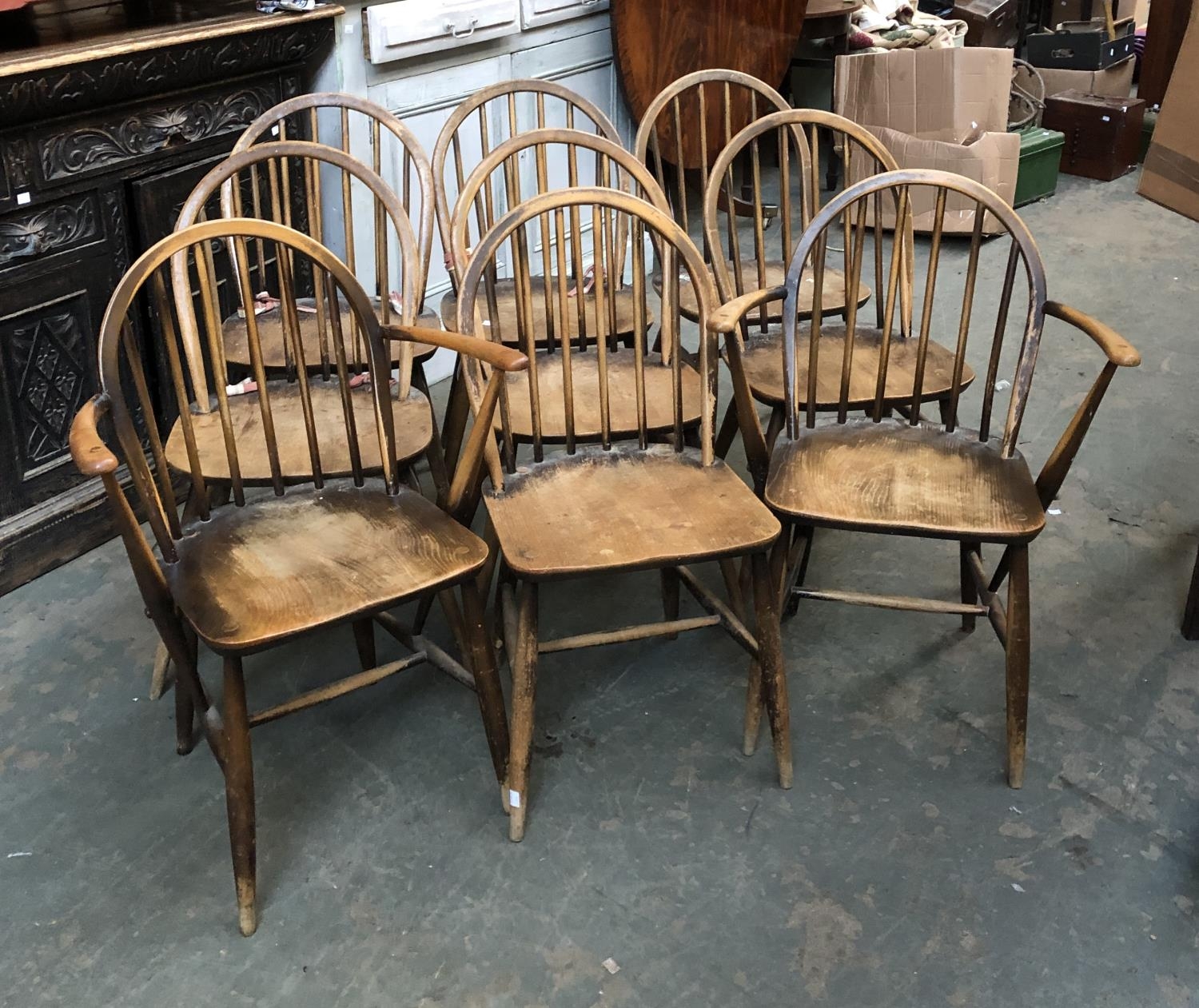 A set of nine beech and elm Ercol hoopback kitchen chairs, comprising two open armchairs, with