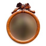 A Victorian mahogany framed circular mirror, with carved ribbon cresting, 38x41cm