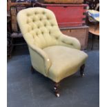 A 19th century button back armchair upholstered in pale green fabric, on turned front legs and