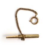 A yellow metal watch key with bolt ring, 6.7g
