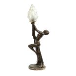 An Art Deco bronze effect plaster figural table lamp in the form of a nude female figure holding a