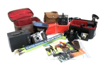 A mixed lot of cameras and equipment to include Kodak Brownie, Kodak Brownie Six-20, Sigma lenses,