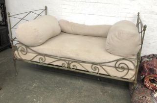 A high quality wrought iron verdigris patinated day bed (damaged), with linen covered bolster