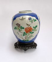A large Chinese blue ground famille verte ginger jar, 22.5cmH, together with a carved hardwood