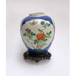 A large Chinese blue ground famille verte ginger jar, 22.5cmH, together with a carved hardwood