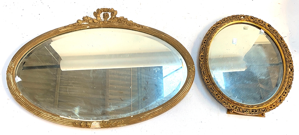 A 19th century oval mirror with laurel cresting and bevelled glass, 73x51cm; together with a further