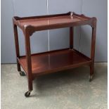 A mahogany two tier hostess trolley on oversized casters, 76x51x72cmH