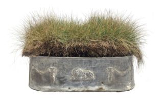 A lead trough planter, rounded ends, the sides cast with swags and central lion, 80cm wide, 32cm