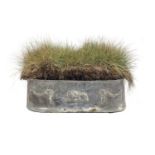 A lead trough planter, rounded ends, the sides cast with swags and central lion, 80cm wide, 32cm