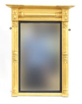 A Regency gilt gesso pier mirror, with lotus turned columns, apparently original plate within an