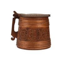 A Scandinavian carved wood tankard, c.1900 , of typical form with hinged lid above the tapered
