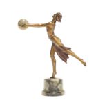 An Art Deco gilt metal figure of a young woman wearing a skirt, holding before her an alabaster orb,