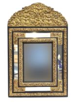 A 19th century French worked metal and ebonised wall mirror, c.1900, in baroque style, the central