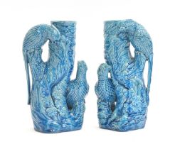 A pair of Chinese turquoise glazed vases modelled with parrots on a tree, 25.5cm high