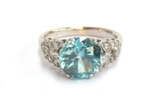 An early 20th century white metal mounted blue zircon and diamond ring, the zircon approx. 4.7cts,