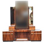 A French Art Deco maccasar ebony dressing table, triple plate mirrors, three plain frieze drawers