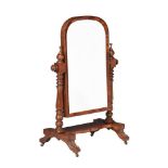 A Victorian mahogany cheval mirror, the domed plate on turned supports, the base with four