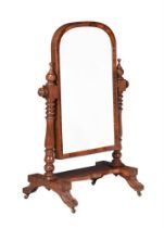 A Victorian mahogany cheval mirror, the domed plate on turned supports, the base with four