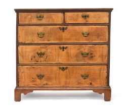 An early 18th century walnut chest of drawers, the moulded top above two short and three