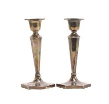 A pair of silver candlesticks by Walker & Hall, Sheffield 1961, of hexagonal tapering form, on