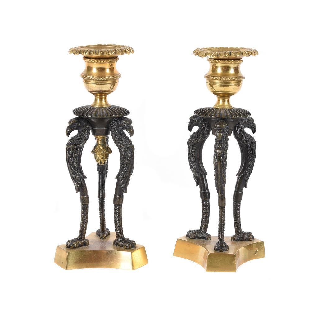 A pair of gilt and patinated metal candlesticks in Empire style, modern, each with single sconce