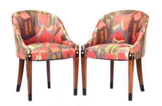 A pair of French Art Deco tub chairs, raised on square tapered legs with ebonised and ivorine inlay,