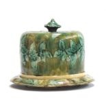 A 19th century majolica cheese cloche with leaf and berry design, 23cm high, 29cm diameter