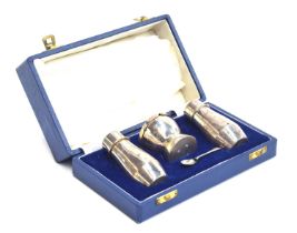 A three piece cased silver cruet by Mappin & Webb, Birmingham 1966, comprising a lidded mustard with