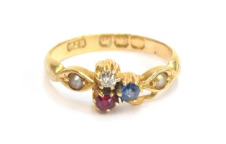 An Edwardian 18ct gold ring set with a diamond, ruby and sapphire clover, flanked by pearls, size J,