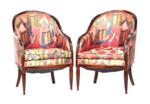 A pair of French mahogany framed tub bergere armchairs in the manner of Sue et Mare, with arched