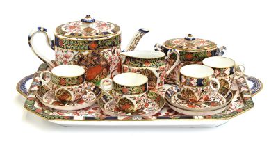 A 19th century Royal Crown Derby cabaret set in Imari pattern 198, date marks for 1884, comprising