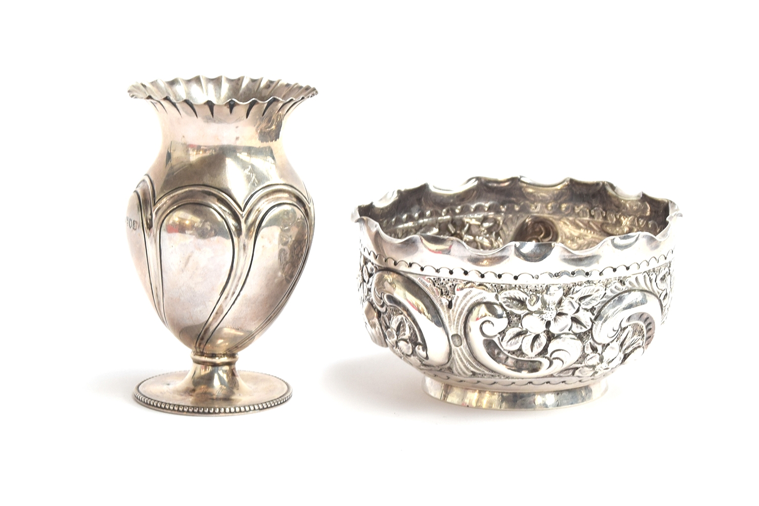 A late Victorian silver bowl by Norton & White, Birmingham 1899, heavily chased with scrolls and