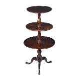 A George III mahogany three tier dumb waiter, c.1780, each tier on a baluster turned column, the