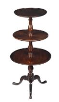 A George III mahogany three tier dumb waiter, c.1780, each tier on a baluster turned column, the