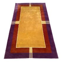 A large thick wool Art Deco style rug, in yellow, red, and purple, 367x218cm