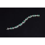 An exquisite 18ct white gold emerald and diamond bracelet, the eight large emeralds approx. a